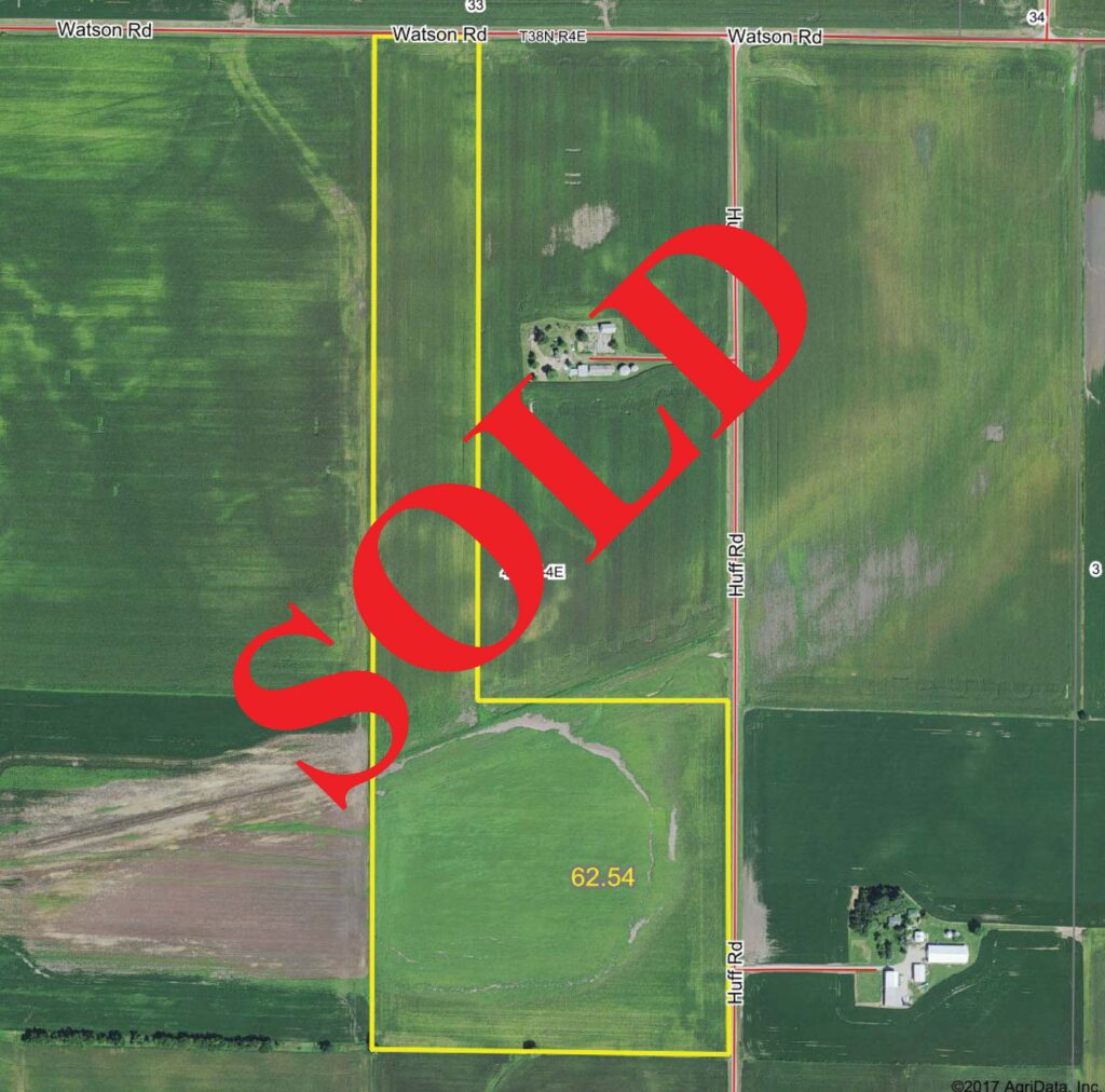 Drone view of farmland, "SOLD" laid over top in bold red text