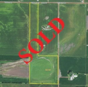 Drone view of farmland, "SOLD" laid over top in bold red text