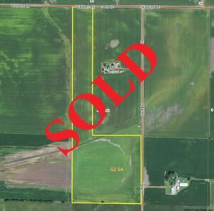 Drone view of farmland, "SOLD" laid over top in bold red text