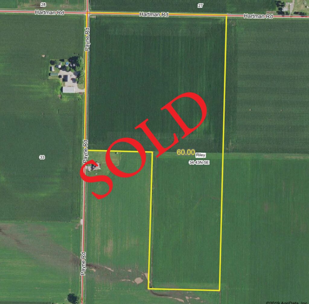 Drone view of farmland, "SOLD" laid over top in bold red text