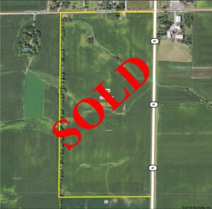 Drone view of farmland, "SOLD" laid over top in bold red text